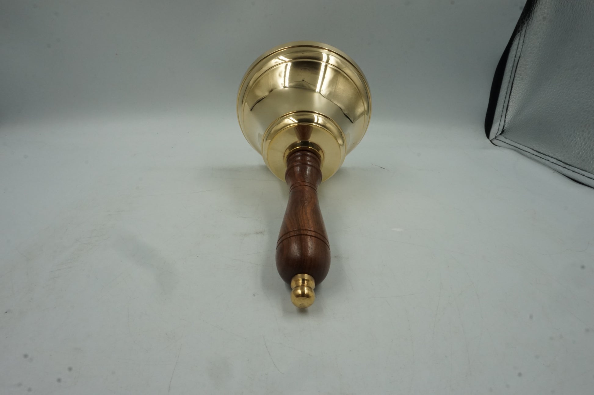handheld brass bell with wooden handle